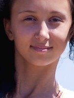 Sexy brunette teen posing bottomless on the beach